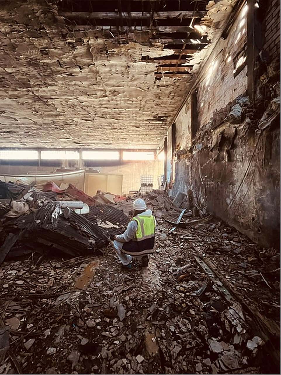 Tècnica de CORT inspeccionant l'interior d'una nau industrial en enderroc